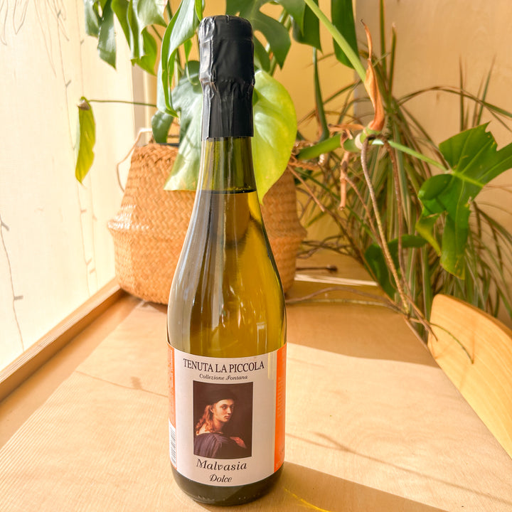 A bottle of white wine. The label reads: Tenuta La Piccola. Malvasia Dolce."