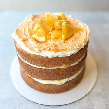 Three-layer cake topped with orange slices.