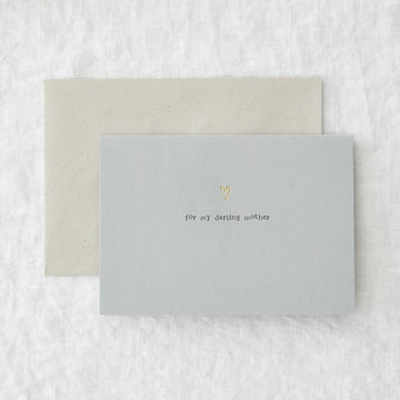 A light blue, horizontal card with a small gold heart. 